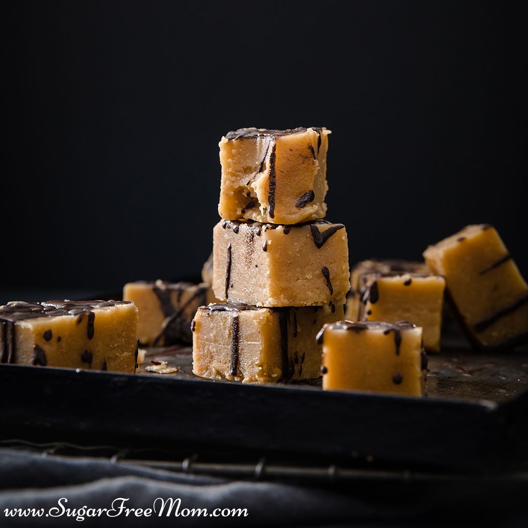 square desserts on a baking sheet drizzled in chocolate