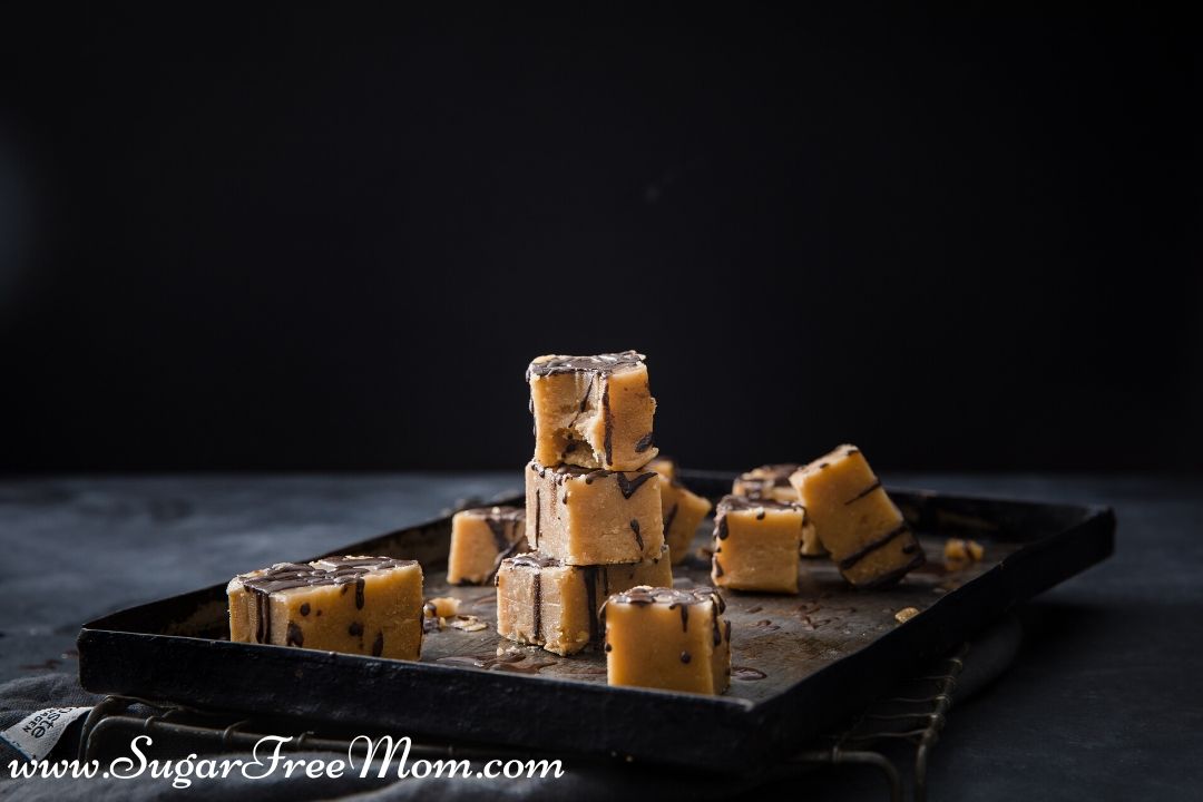 square desserts on a baking sheet drizzled in chocolate