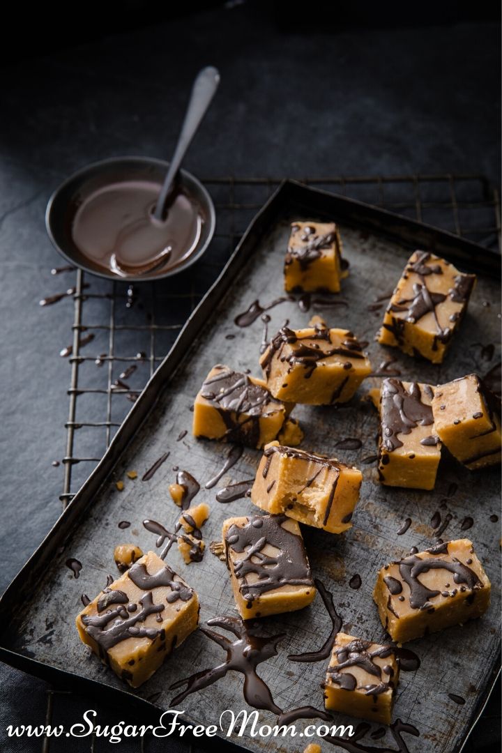 square desserts on a baking sheet drizzled in chocolate