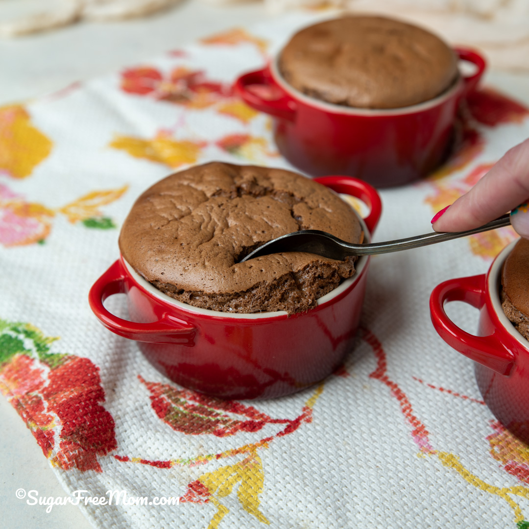 spoon cutting into mini keto chocolate souffle