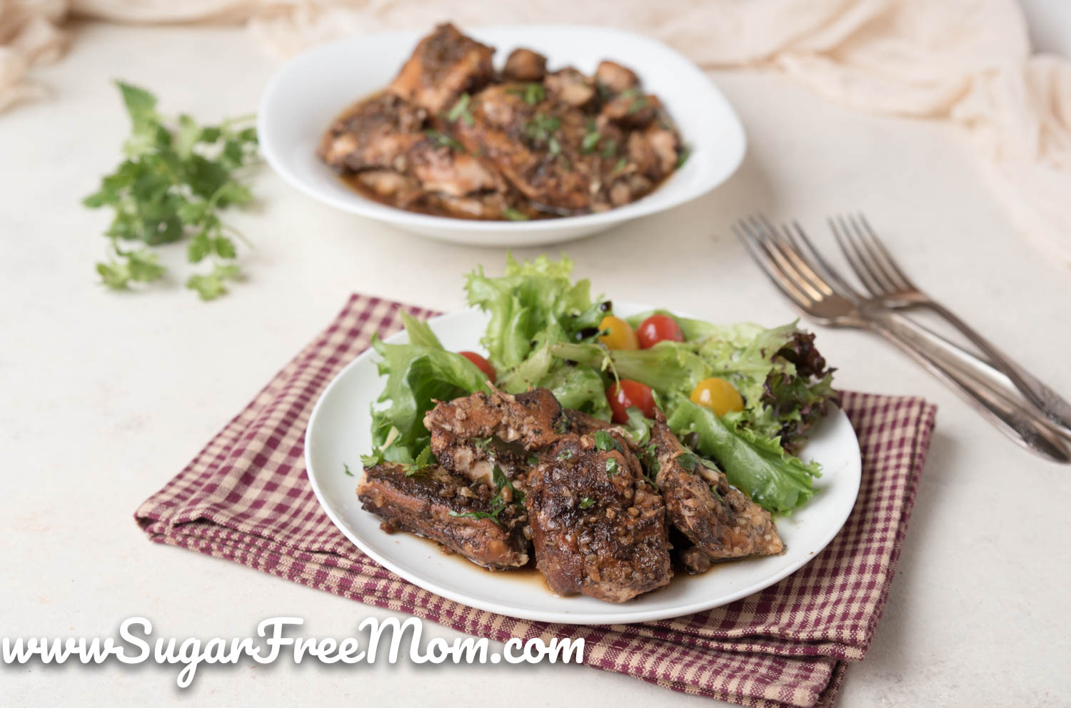 plate of chicken thighs and green salad