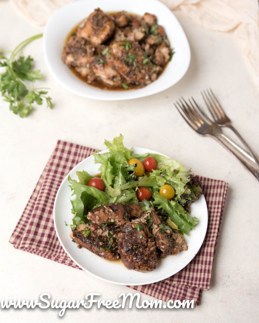 plate of chicken thighs and green salad