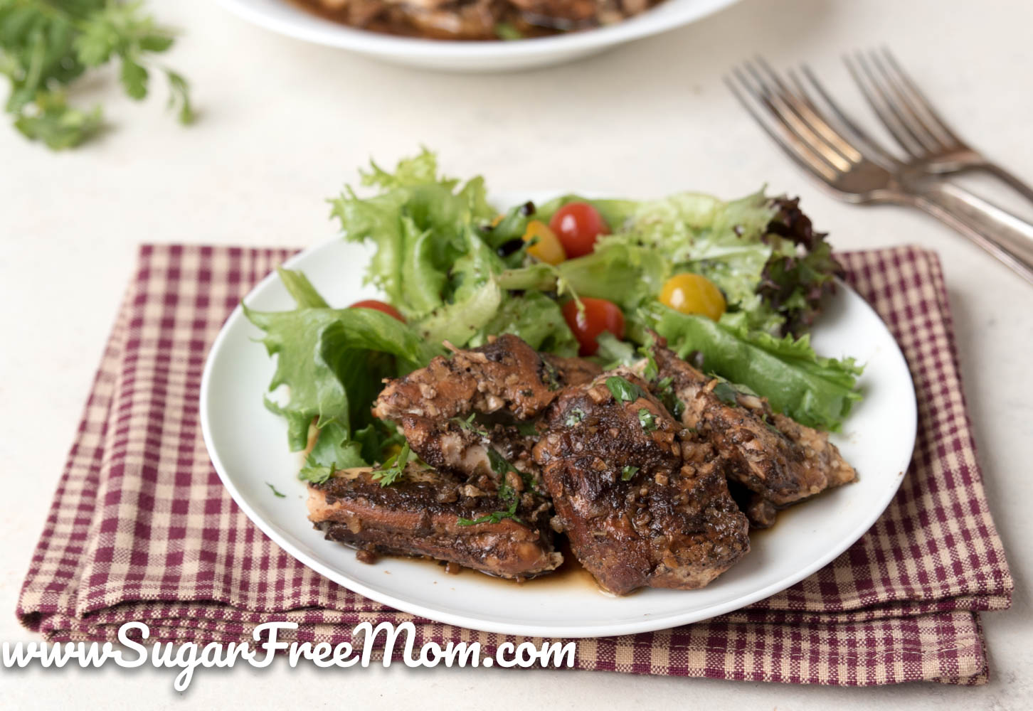 plate of chicken thighs and green salad