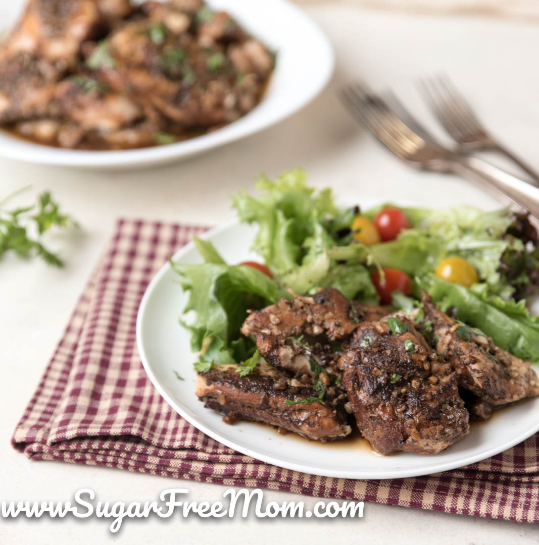 plate of chicken thighs and green salad