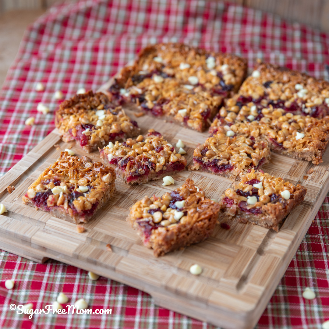 These Keto Cranberry White Chocolate Magic Bars are a festive, low carb, nut-free holiday bar with a golden brown crust, chewy cranberries, creamy layers, and the perfect holiday twist!