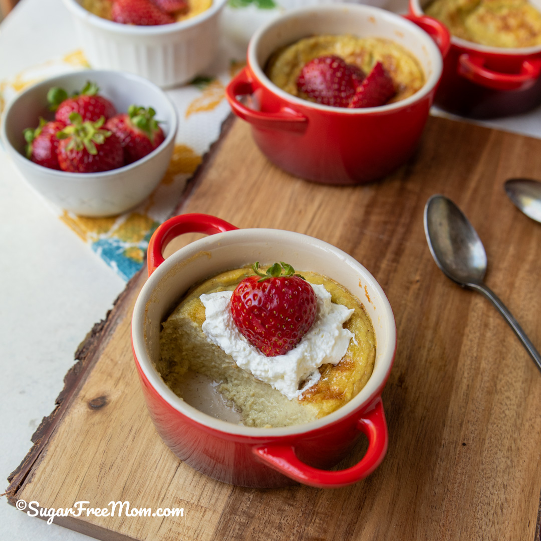 Easy keto egg custard recipe made with coconut milk and topped with whipped cream and berries.