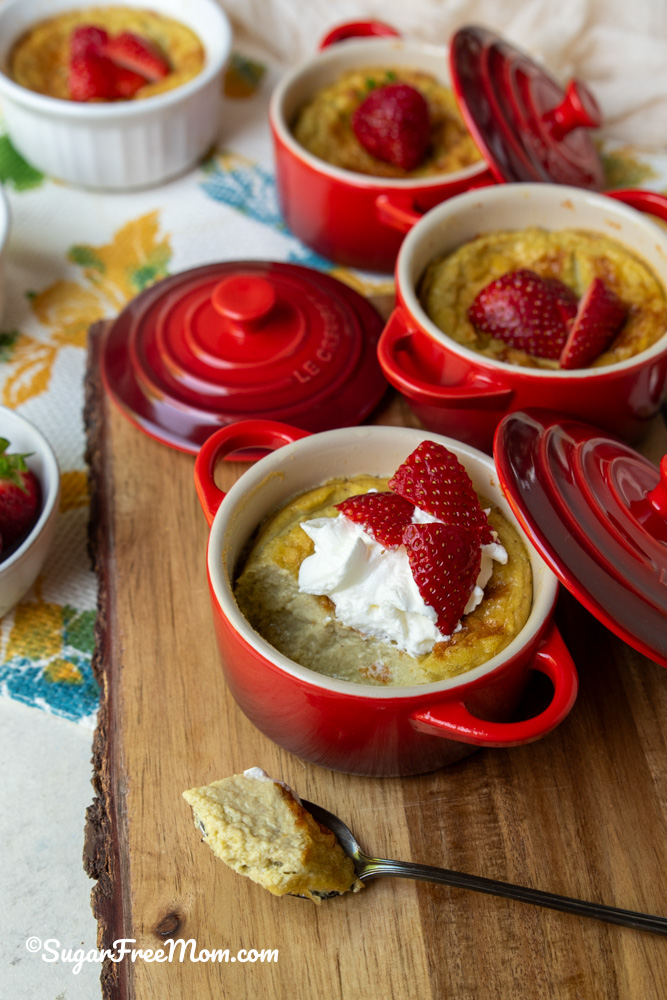 Low carb baked coconut custard topped with whipped cream and fresh strawberries.