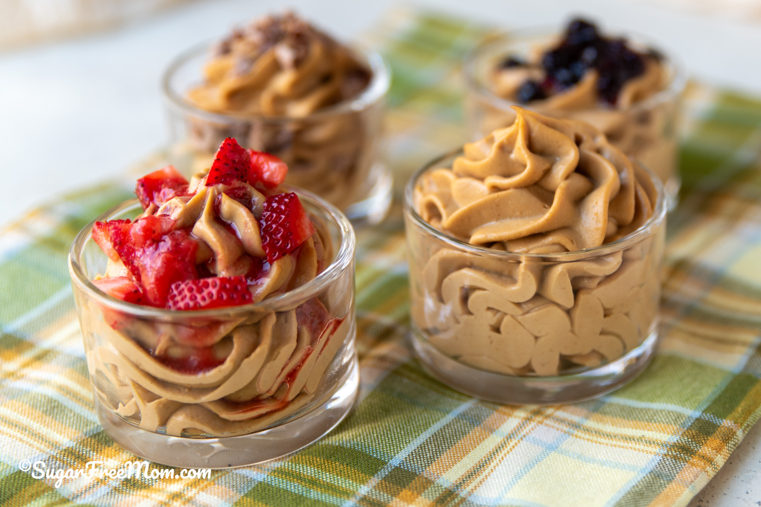 Side view of keto peanut butter protein fluff topped with strawberries and no topping