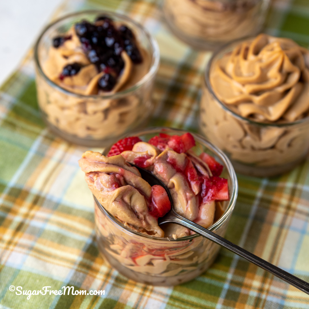 A spoonful of strawberry topped keto peanut butter protein fluff