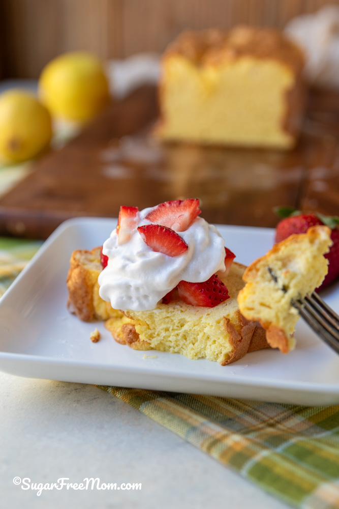 Close up of Keto Lemon Loaf topped with sugar free whipped cream and strawberries