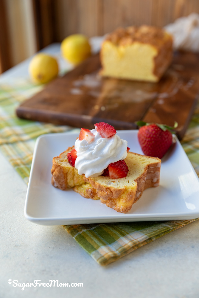 A Slice of Keto Lemon Loaf topped with Sugar Free Whipped Cream and Strawberries