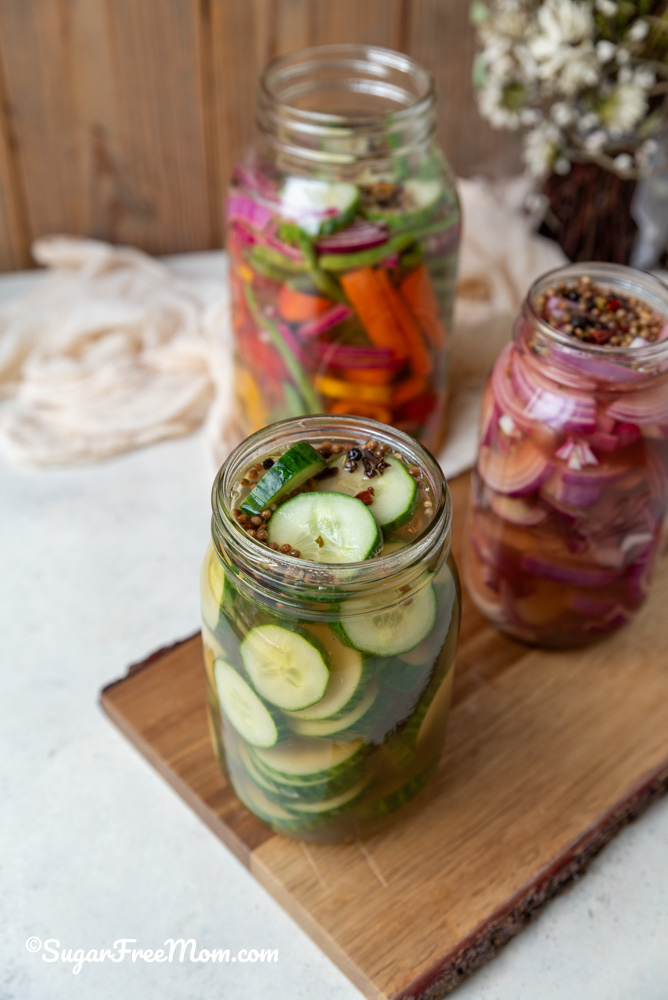 sugar free brine and pickling spices on sliced cucumbers in mason jar