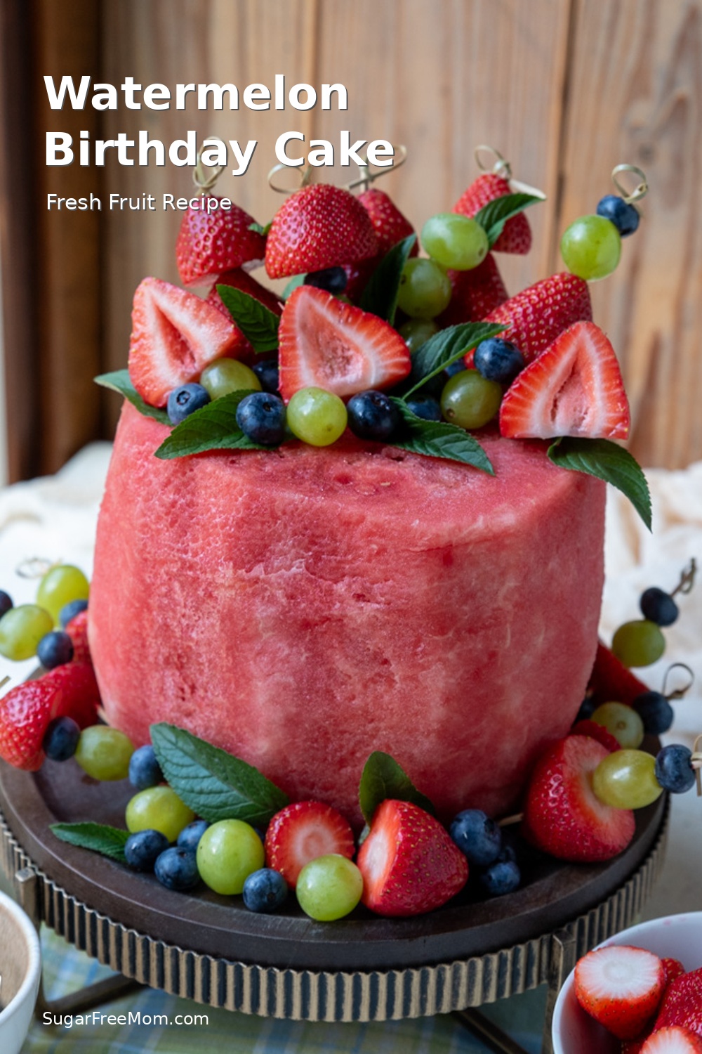 This easy watermelon birthday cake is made with fresh strawberries, blueberries, grapes and mint. A beautiful fresh fruit cake recipe for birthdays, baby showers, graduation parties and summer celebrations. Naturally gluten-free and made with whole food ingredients.