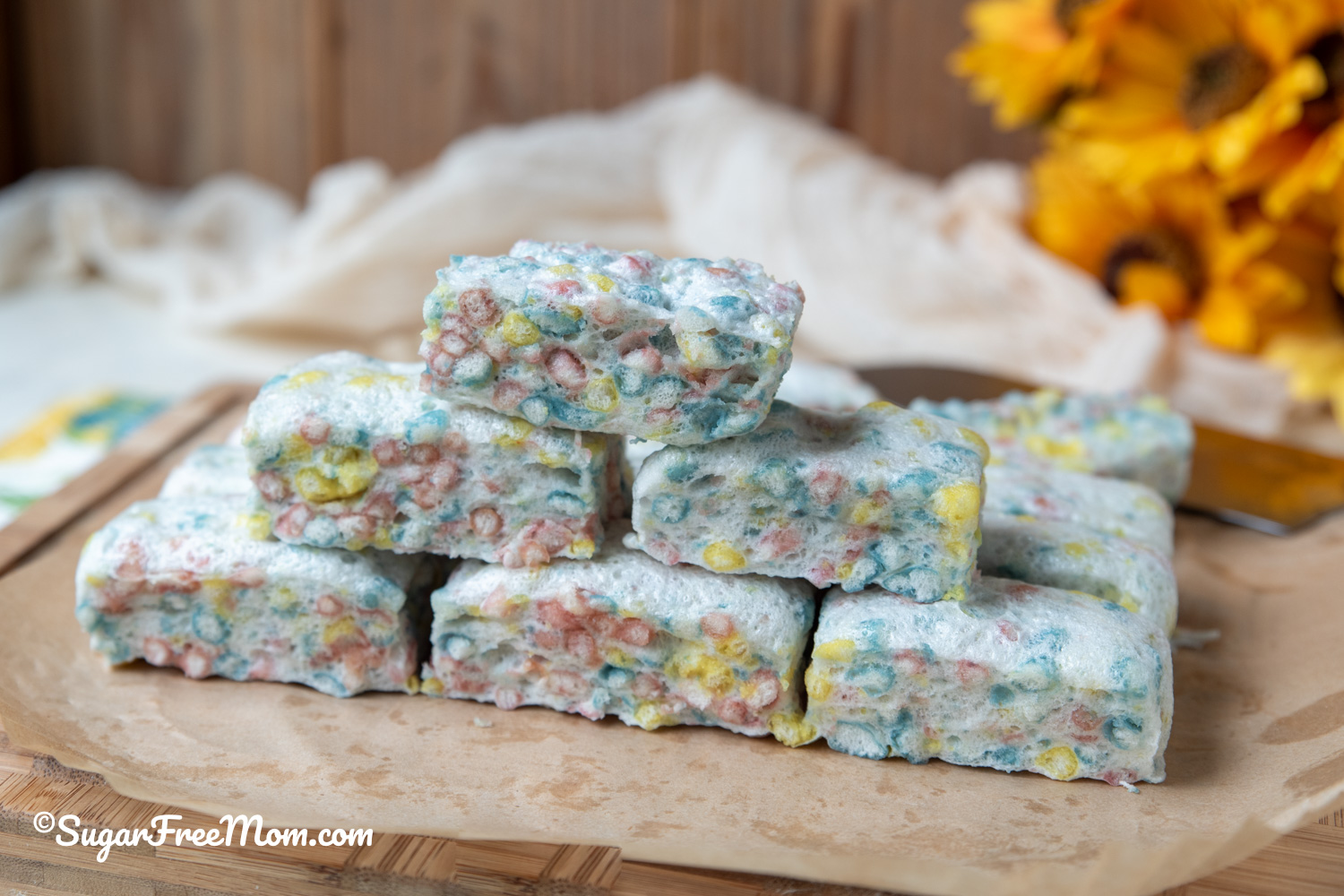 horizontal image of pyramid stack of keto marshmallow treats on parchment paper