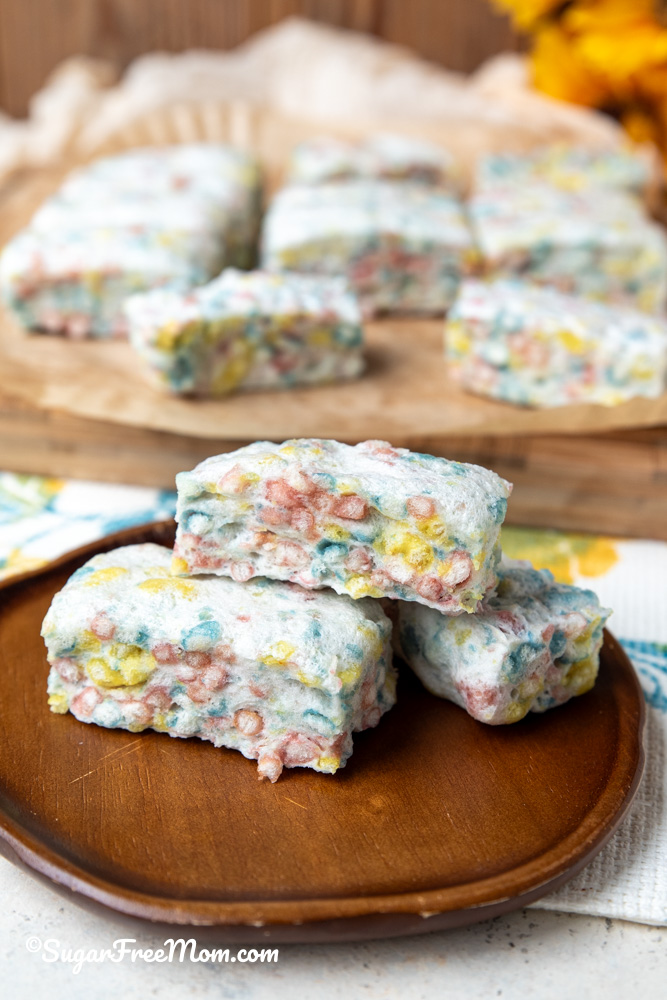 vertical image of 3 keto marshmallow rice krispies treats sitting on a plate