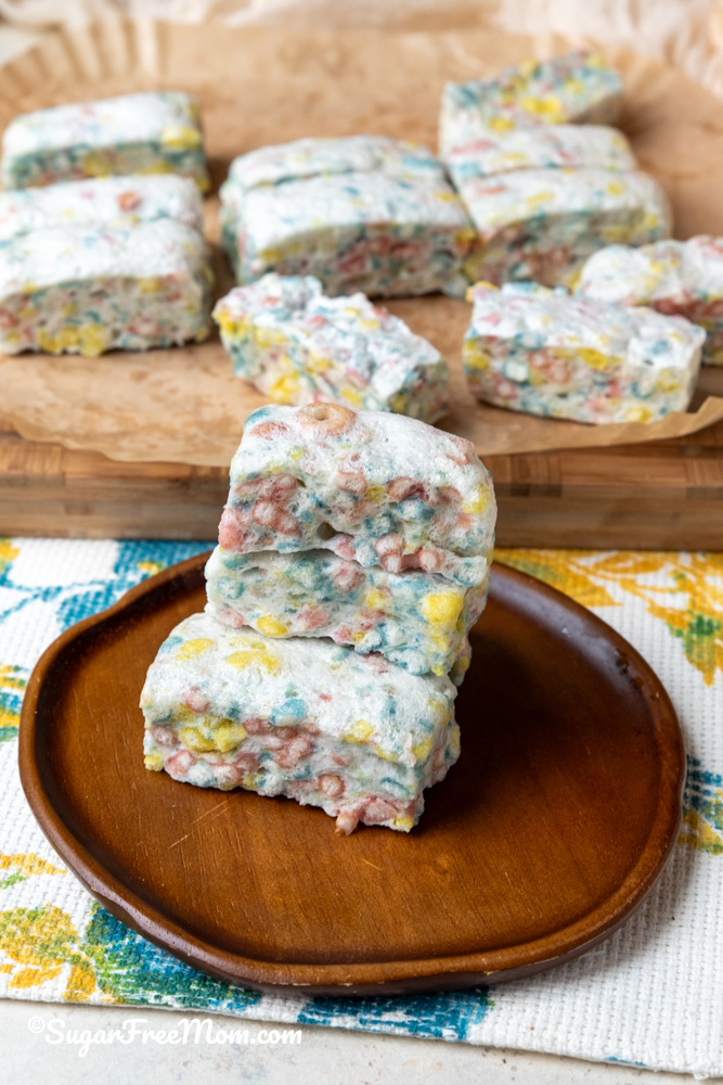 vertical image of 3 stacked keto marshmallow treats sitting on a plate