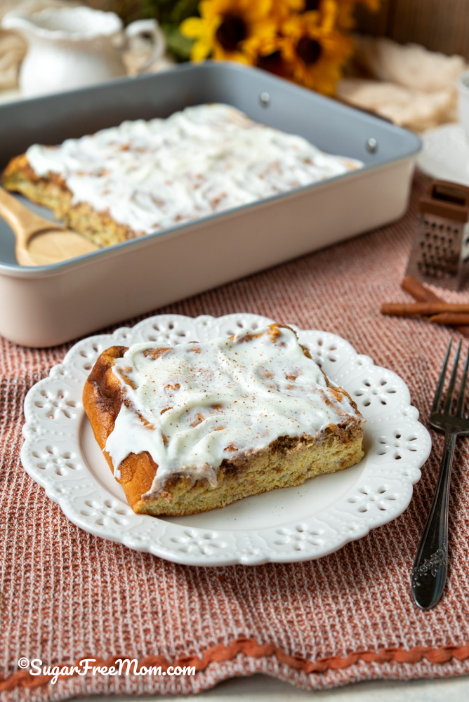 vertical image of sheet pan pancake on a plate topped with sugar free icing