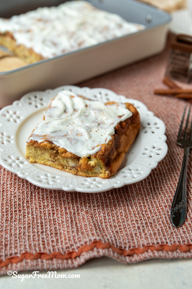 vertical image of sheet pan pancake on a plate topped with sugar free icing