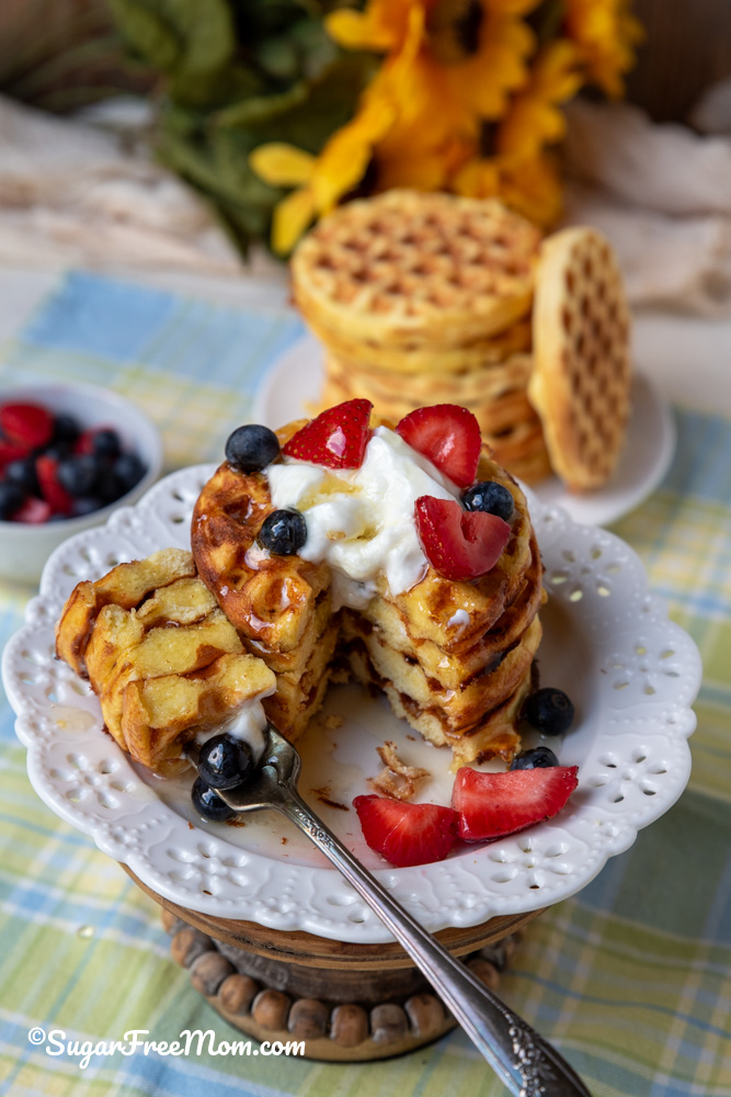 4 stacked keto coconut flour waffles on a plate and cake stand