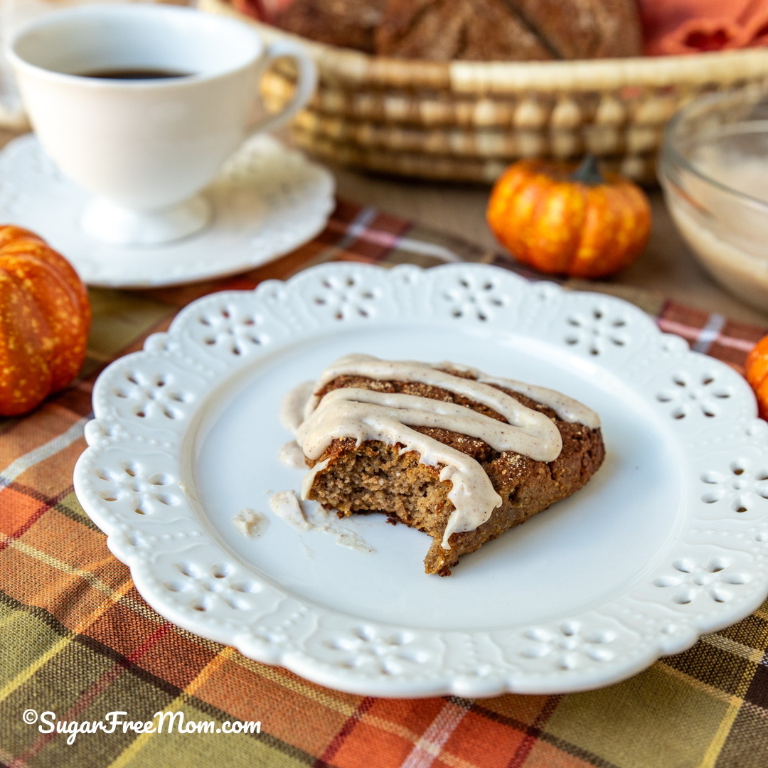 close up square image of inside crumb of keto pumpkin scone on a plate