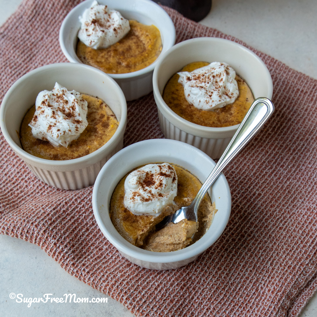 square image of 4 small ramekins with one spoonful of keto pumpkin ricotta custard
