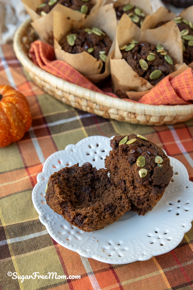 low carb chocolate pumpkin muffin split in half on a white plate
