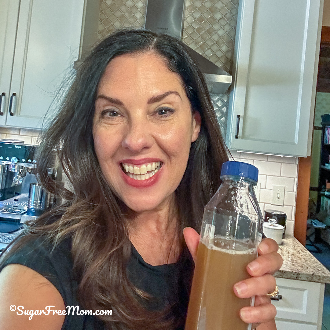 Brenda/Sugar Free Mom holding a clear bottle of Unimate